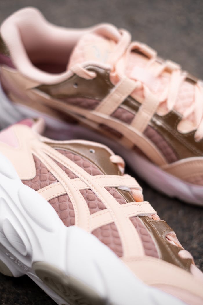 Close-up of trendy pink and beige athletic shoes, perfect for sports fashion.